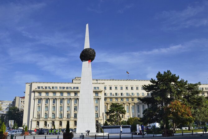 Bucharest one day tour with Parliament Palace and Village Museum - Revolution Square monument: listening mode for a few minutes